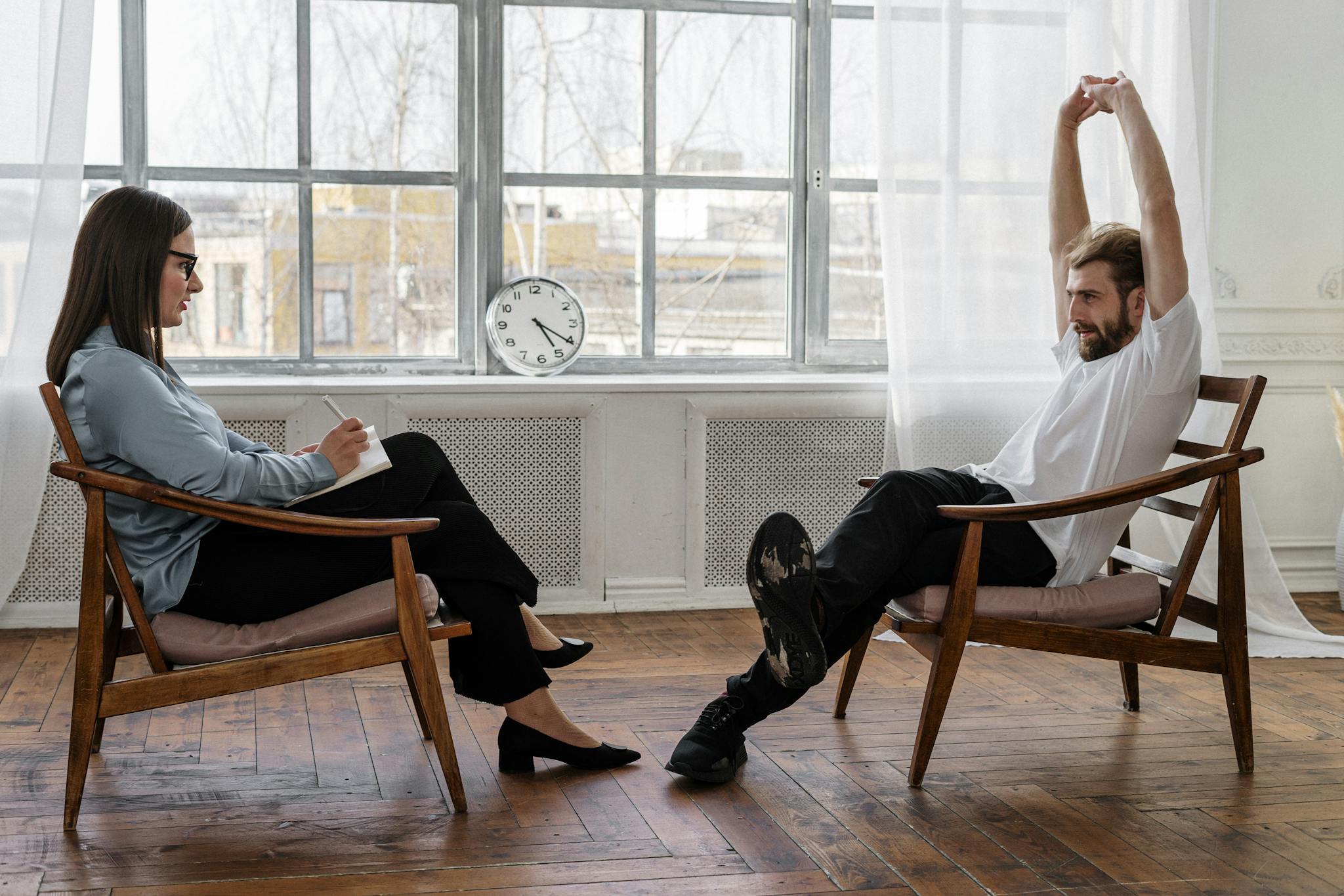 A counselor and client engaged in a therapy session indoors, reflecting on emotions and solutions.